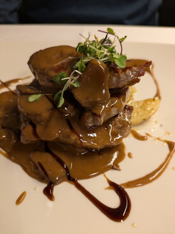 Iberico pork presa with wild mushrooms and wine sauce